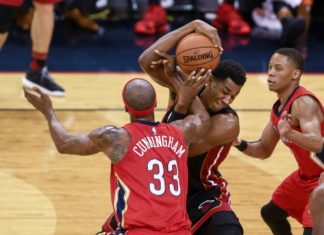Heat's Hassan Whiteside grabs a rebound from Pelicans' forward Dante Cunningham