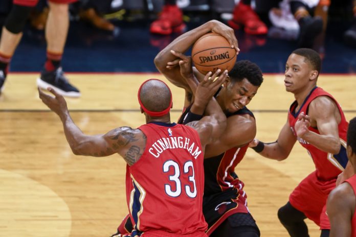 Heat's Hassan Whiteside grabs a rebound from Pelicans' forward Dante Cunningham