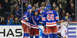 New York Rangers players celebrate after scoring a goal in 2018