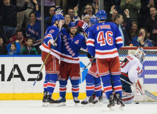New York Rangers players celebrate after scoring a goal in 2018