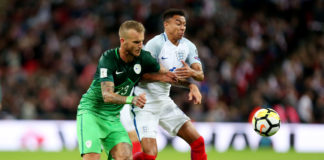 England's Jesse Lingard (right) in duel with Slovenia's Aljaz Struna