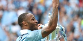 Raheem Sterling with Manchester City celebrates with the FA Cup Trophy in 2019