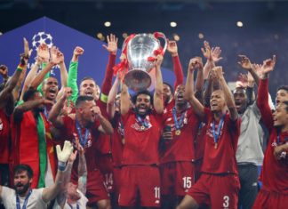 Mohamed Salah of Liverpool celebrates with the Champions League Trophy in 2019
