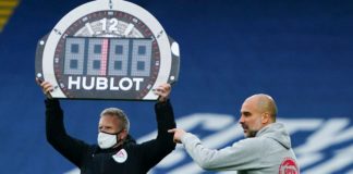 Manchester City Manager Pep Guardiola points as fourth official Jon Moss holds up the Hublot substitutes board in 2021