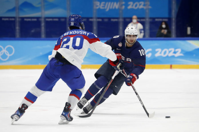 Team United States forward Matty Beniers (10) and Team Slovakia forward Juraj Slafkovsky (20) during the Beijing 2022 Olympic Winter Games