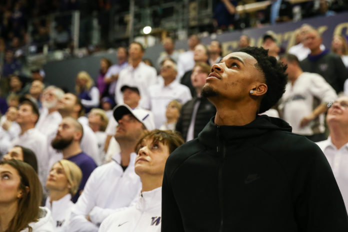 Dejounte Murray attending a college basketball game