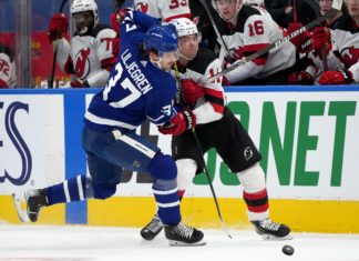 Maple Leafs' Timothy Liljegren (37) in a duel with Devils forward Andreas Johnsson (11)