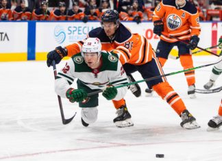 Kevin Fiala (22) is checked by Edmonton Oilers' Philip Broberg (86)