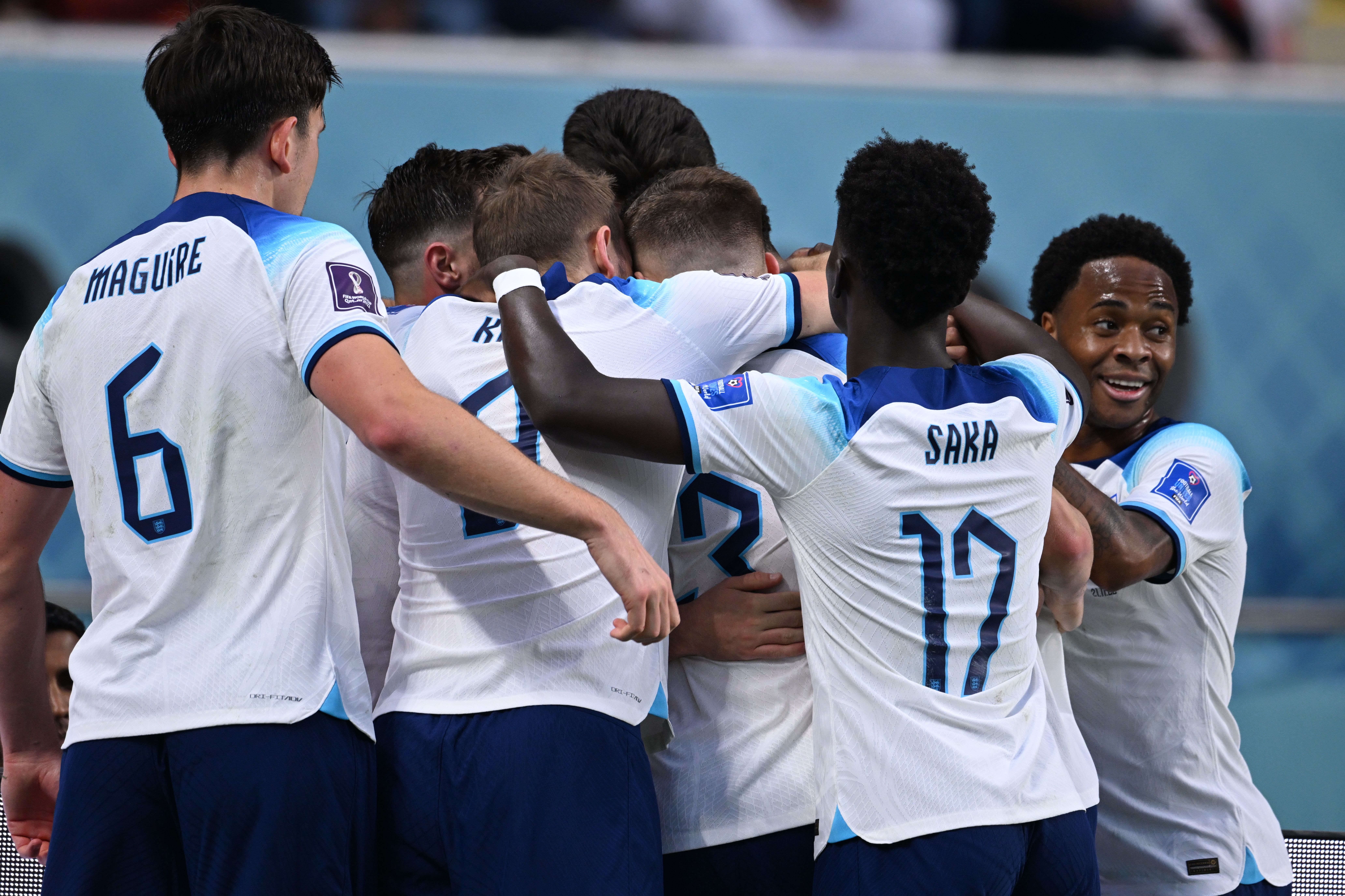 England's' Harry Maguire (DF) 6, Harry Kane (FW) 9, Luke Shaw (DF) 3, Bukayo Saka (FW) 17, and Raheem Sterling (FW) 10, celebrate a goal during the FIFA World Cup in November 2022