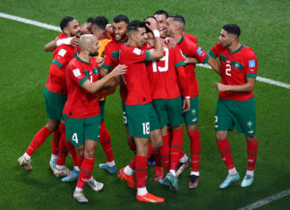Yousseff En-Nesyri of Morocco scores the opening goal and celebrates with his team during Morocco v Portugal during the 2022 FIFA World Cup