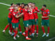 Yousseff En-Nesyri of Morocco scores the opening goal and celebrates with his team during Morocco v Portugal during the 2022 FIFA World Cup