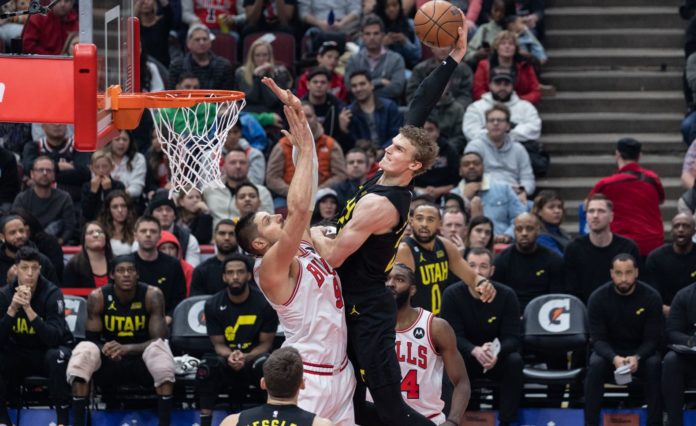 Lauri Markkanen (23 Utah Jazz) dunks the ball over Nikola Vucevic (9 Chicago Bulls) during the game between the Chicago Bulls and Utah Jazz in January 2023