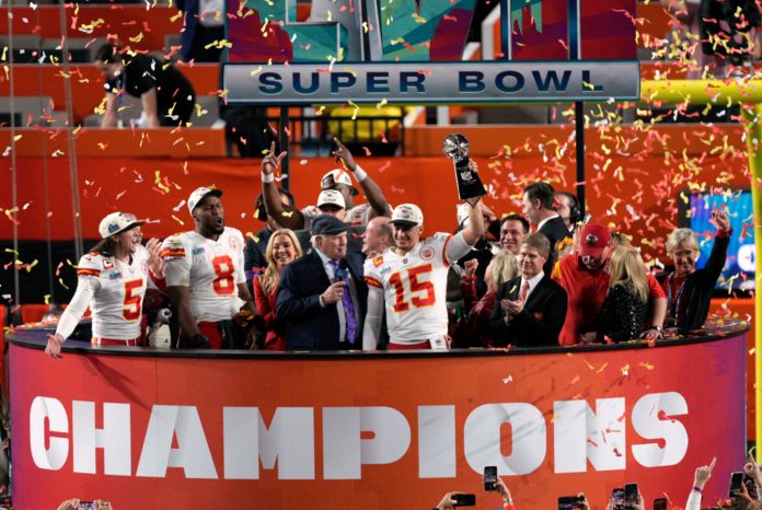 Kansas City Chiefs quarterback Patrick Mahomes lifts The Vince Lombardi Trophy at Super Bowl LVII in February 2023