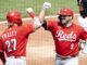 Cincinnati Reds first baseman Mike Moustakas (9) bump elbows with Cincinnati Reds right fielder Jake Fraley (27) in 2022