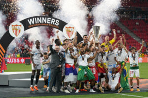 Ivan Rakitic and Jesus Navas of Sevilla FC lift the UEFA Europa League trophy after the team's victory during the UEFA Europa League 2022/23 final match between Sevilla FC and AS Roma in May 2023