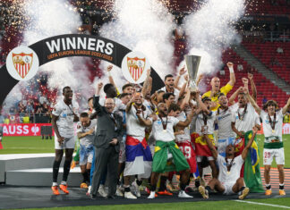 Ivan Rakitic and Jesus Navas of Sevilla FC lift the UEFA Europa League trophy after the team's victory during the UEFA Europa League 2022/23 final match between Sevilla FC and AS Roma in May 2023