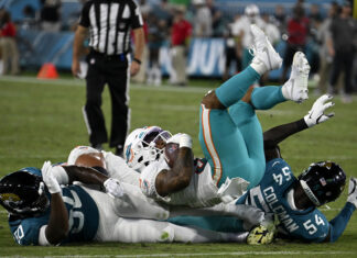 Dolphins Wide Receiver Daewood Davis is tackled by Jaguars in Florida, August 26, 2023.
