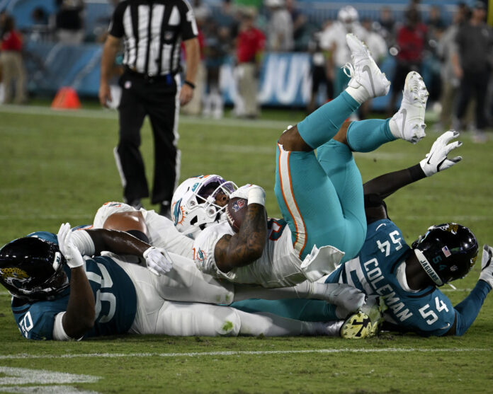 Dolphins Wide Receiver Daewood Davis is tackled by Jaguars in Florida, August 26, 2023.