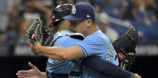 Tampa Bay Rays reliever Robert Stephenson (R) hugs catcher Christian Bethancourt in July 2023