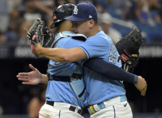 Tampa Bay Rays reliever Robert Stephenson (R) hugs catcher Christian Bethancourt in July 2023