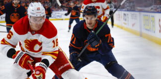 Calgary Flames defenceman Nikita Zadorov, left, is chased by Edmonton Oilers centre Ryan McLeod in 2022
