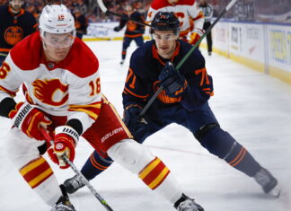 Calgary Flames defenceman Nikita Zadorov, left, is chased by Edmonton Oilers centre Ryan McLeod in 2022