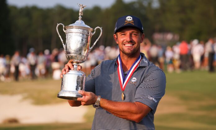 Bryson DeChambeau of the United States with the championship trophy after winning the 124th U.S. Open golf championship in June 2024