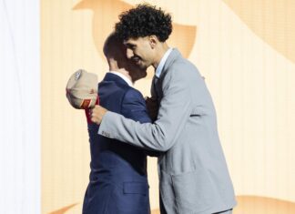 Commissioner Adam Silver shakes hands with Zaccharie Risacher, selected as number one by the Atlanta Hawks, in the first round of the 2024 NBA Draft in June 2024