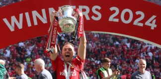 Jonny Evans lifting The FA Cup Trophy after The Emirates FA Cup Final soccer match between Manchester City and Manchester United in May 2024