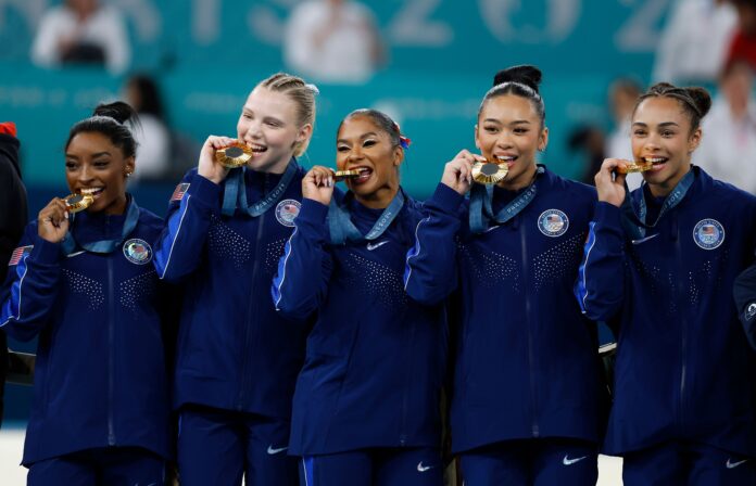 Simone Biles of USA and team mates celebrate winning the Gold Medal in the Artistic Gymnastics Women's Team Final Paris 2024 Olympic Games in July 2024