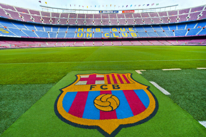 FC Barcelona emblem on the grass at Camp Nou stadium