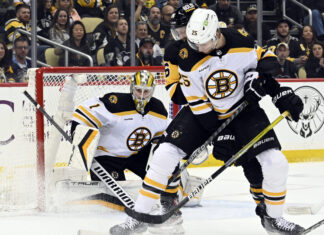 Jeremy Swayman and Brandon Carlo (25) with the Boston Bruins in April 2023