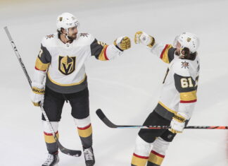 Vegas Golden Knights' Shea Theodore (27) celebrates his goal with teammate Mark Stone (61)