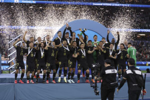 Mexico midfielder EDSON Ã?LVAREZ lifts the CONCACAF Nations League championship trophy after the 2025 CONCACAF Nations League final in March 2025