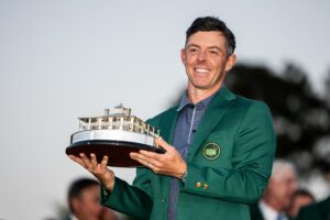 Rory McIlroy of Northern Ireland poses with the Masters trophy during the Green Jacket Ceremony after winning the 2025 Masters Golf Tournament in April 2025